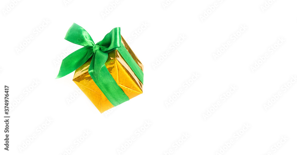 Shiny yellow gift box with green ribbon isolated on white background. Shiny yellow gift box with green ribbon isolated on white background.