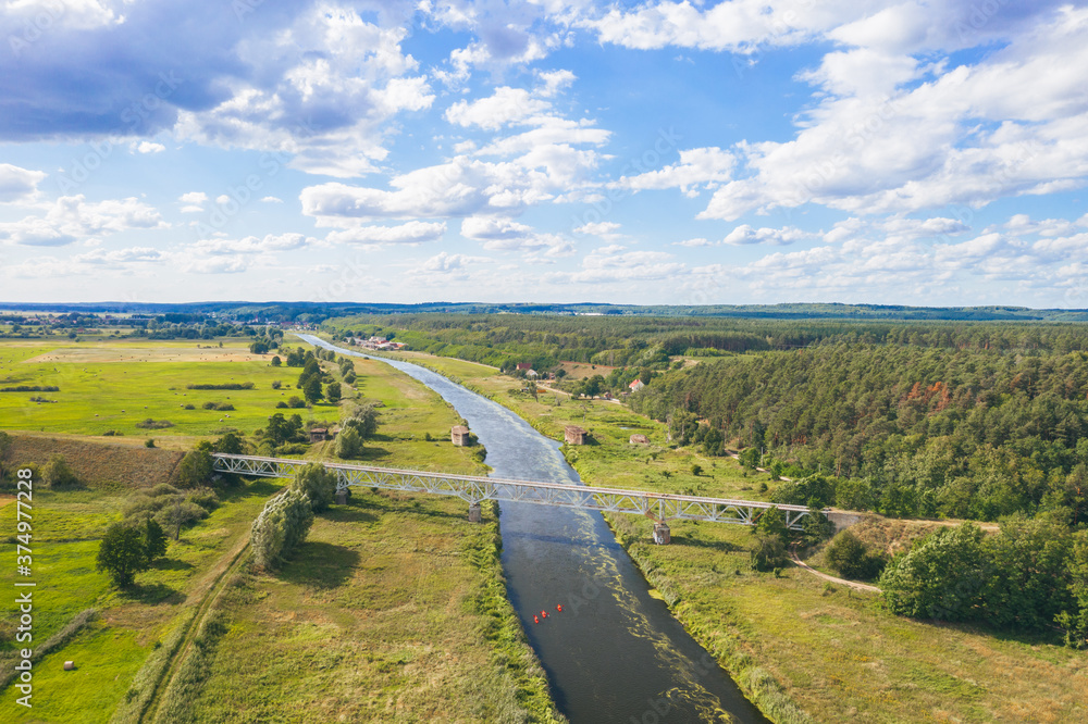 Aerial view over historical german dam combined with a railroad embankment built in 1938 for defense purposes. Drezdenko / Poland.