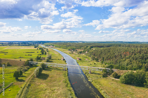 Aerial view over historical german dam combined with a railroad embankment built in 1938 for defense purposes. Drezdenko / Poland.  photo