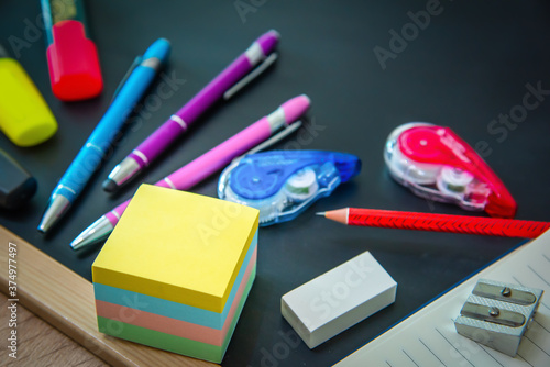  Colorful school accessories on a chalkboard photo