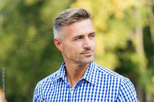 casual business fashion. male beauty and fashion. mature handsome man outdoor. well groomed man looking away. confident guy wear checkered shirt. unshaven male has graying hair