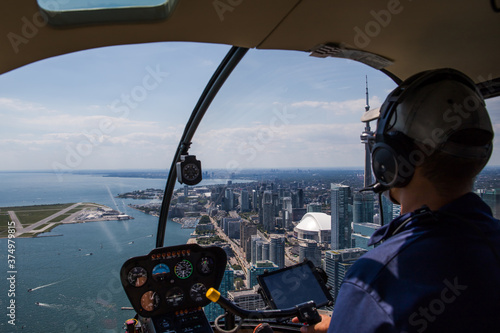 Photography Inside view of a helicopter in flight, with man pilot