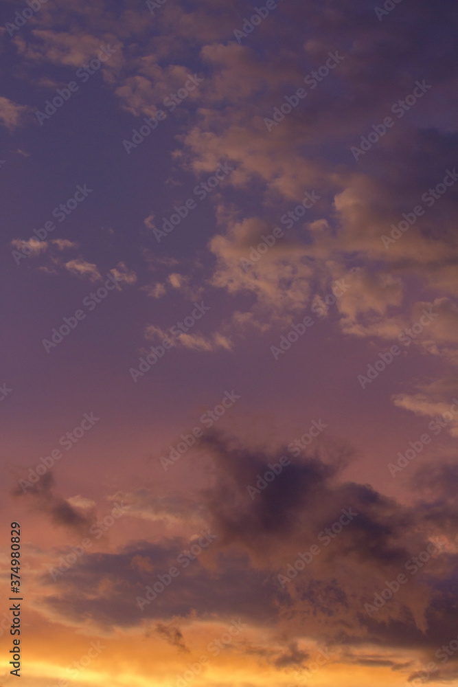 Magical sunset. Cloudscape. View of the dramatic sky and clouds during twilight with beautiful dusk colors, purple, orange and magenta. 