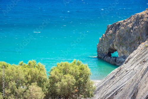 Fototapeta Naklejka Na Ścianę i Meble -  The amazing tropical beach of Panagia Tripiti, in Crete, with sandy beach, turquoise water and some lucky campers, Greece.