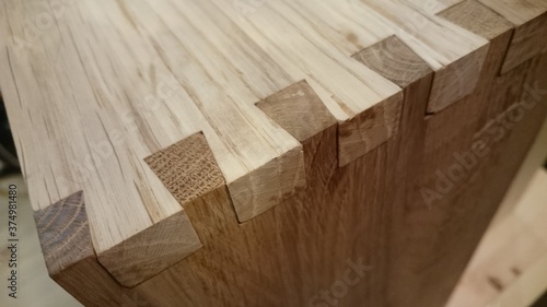 Dovetail joinery on oak wood. Dark and light wood photo