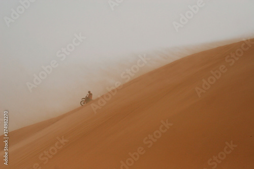 Rally biker on sand dune