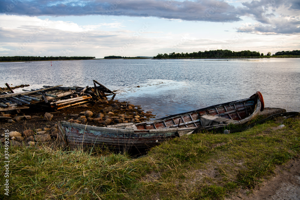 landscape of the island against the background of old wooden boats lying on the shore landscape of the island against the background of old wooden boats lying on the shore