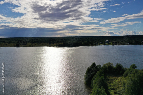 panoramic view of the island with old wooden buildings on the lake filmed from a drone