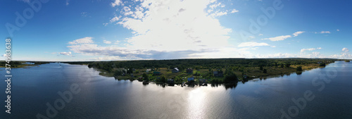 Fototapeta Naklejka Na Ścianę i Meble -  panoramic view of the island with old wooden buildings on the lake filmed from a drone