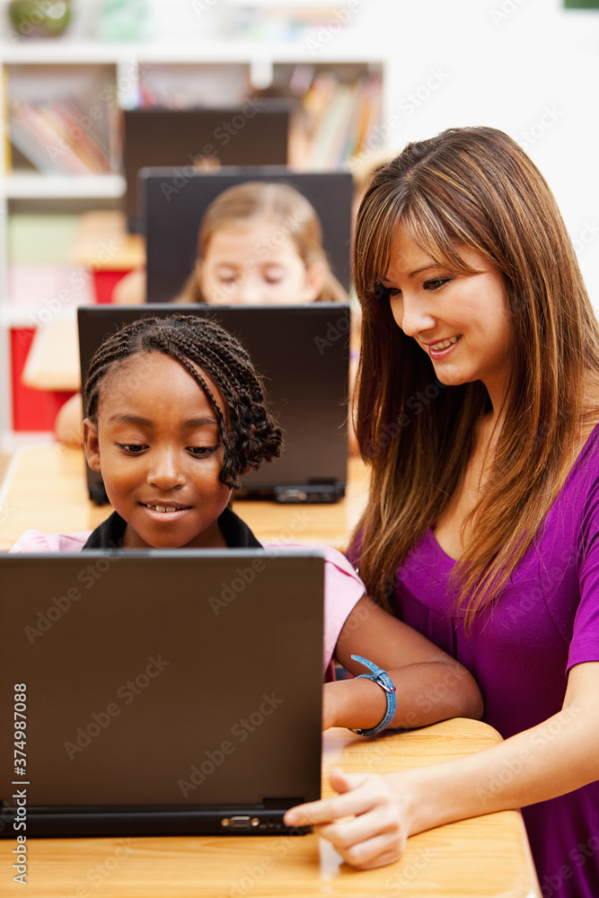 Classroom: Teacher Helps Student with Laptop Classroom: Teacher Helps Student with Laptop