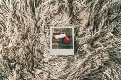 Instant Picture Showing Balloons Lying on a Shag Rug photo