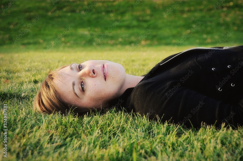 Young Woman Laying In Grass Young Woman Laying In Grass
