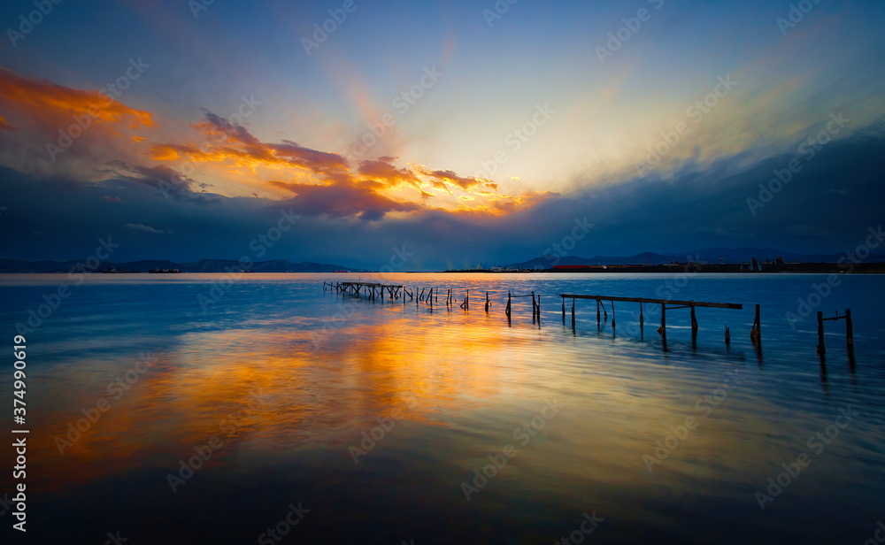 The remnants of an old dock during sunset. The remnants of an old dock during sunset.