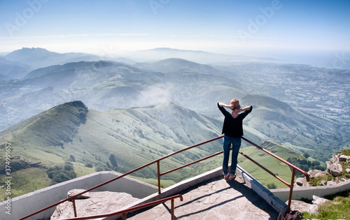 Young woman gazing at Pyrenees Mountains photo