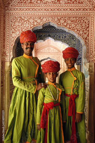 India, Jaipur, Samode Palace, father and sons in hallway, portrait photo