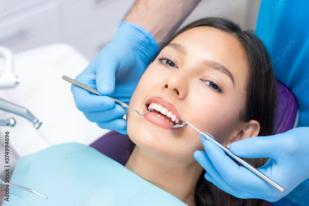 dentist examines the patients teeth at the dentist. dentist examines the patients teeth at the dentist.