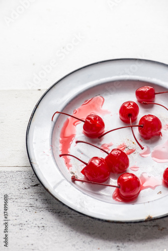 Maraschino cherries on a vintage enamel wear plate photo