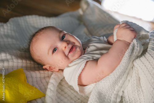 Five month old baby smiling before going to bed 