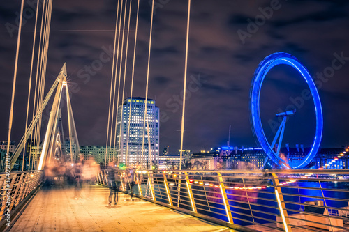 Bridge and Millenium Wheel in London by night