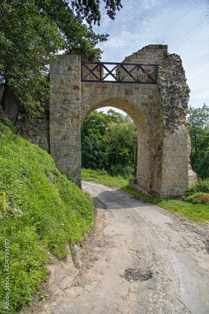 old stone historic gate in ruin with an old stone castle in Poland in Dobczyce