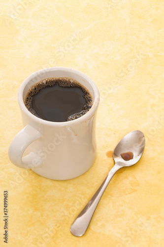 Retro coffee mug and spoon on diner counter photo