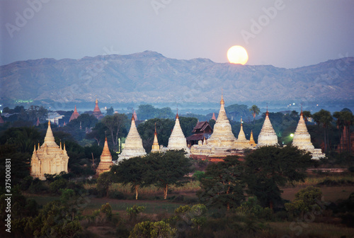 Moon rising over the Buddhist temples and pagodas at archaeological site, Bagan (Pagan), Myanmar (Burma), Asia photo