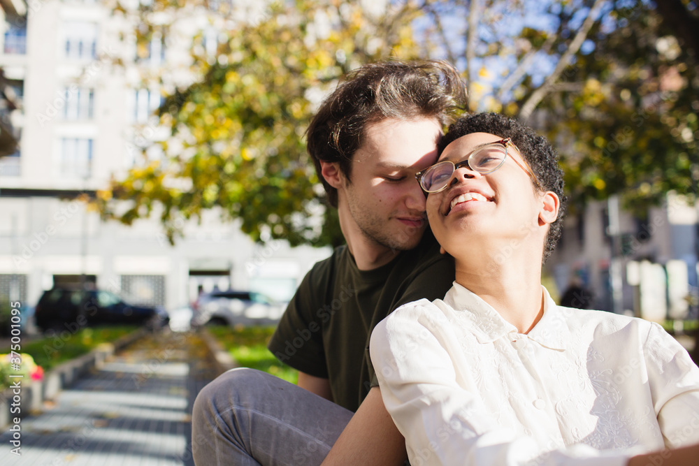 Young couple in love sitting outdoors Young couple in love sitting outdoors