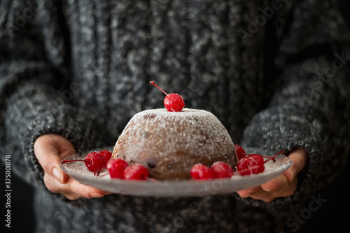 Woman serving Christmas pudding