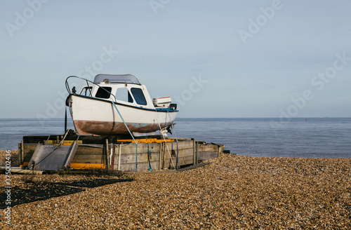 Fishing boat on an empty beach, Kent, UK.