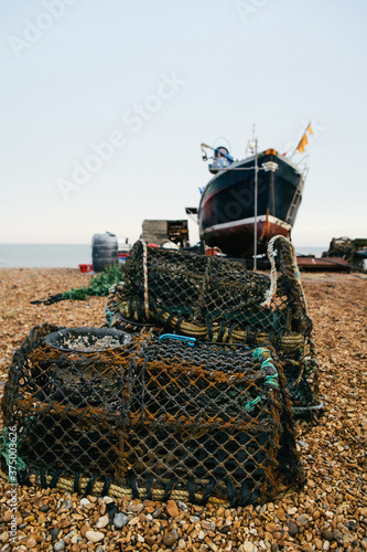 Lobster pots and fishing boat on a quiet beach in Kent. photo