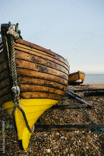 Traditional small wooden fishing boat on the shore. photo