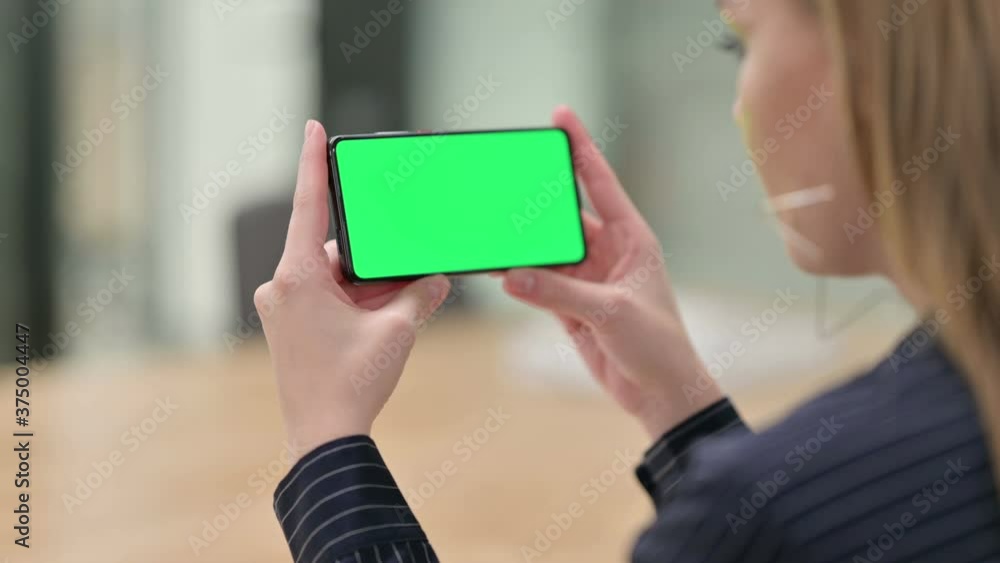 Rear View of Businesswoman Watching Smartphone with Chroma Screen Rear View of Businesswoman Watching Smartphone with Chroma Screen