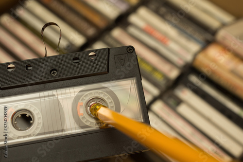 Pencil being used to rewind tape in cassette photo