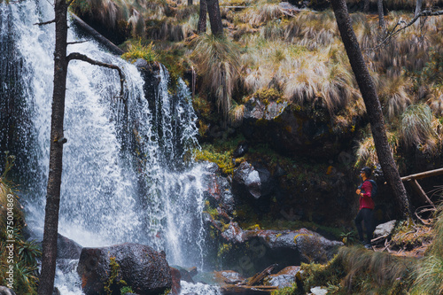 wearing a mask ,Man looking at the Waterfall in Izta-Popo Zoquiapan National Park photo
