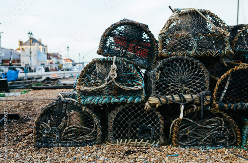 A stack of lobster pots on the beach ready to be loaded onto a fishing boat. photo