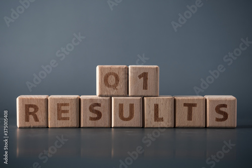 Q1 results, wooden block with text. Business concept.