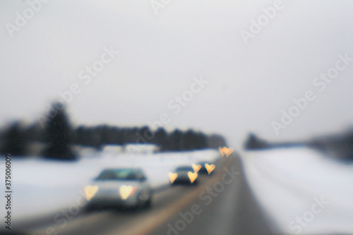 Heart Shaped Car Headlights On A Winter Road photo