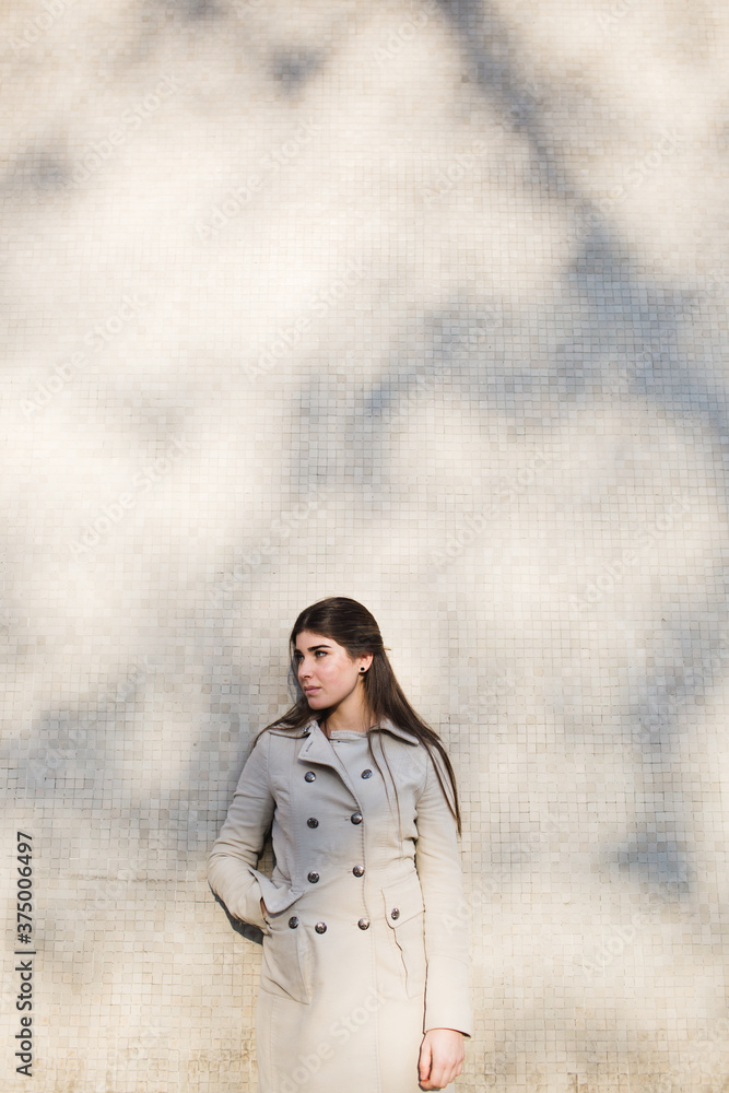 Beautiful young woman leaning against the wall Beautiful young woman leaning against the wall