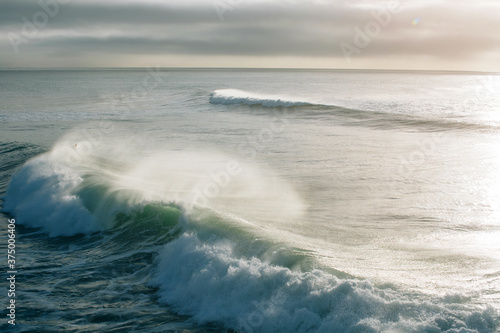 Powerful ocean waves with lots of spray photo