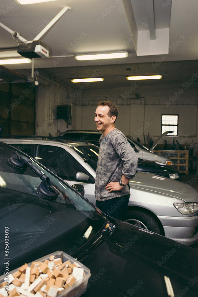 Man Laughing in Auto Repair Shop Man Laughing in Auto Repair Shop