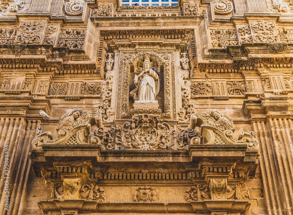 Details of the façade of the Baroque cathedral of Sant'Agata built in the 17th century, Gallipoli, Salento, Puglia region, Italy. Facade decorated in carparo, a local limestone.