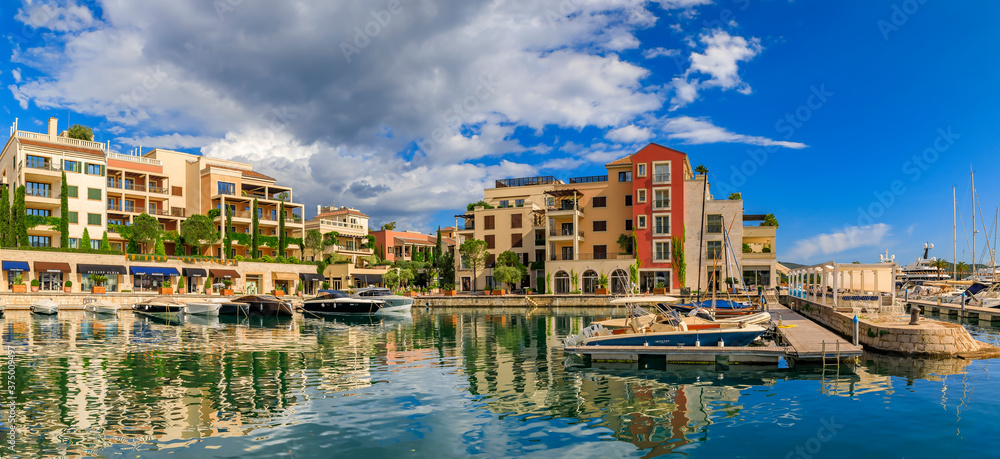 Scenic view of the Adriatic Sea marina with luxury residential buildings and boats in the background in Tivat Montenegro