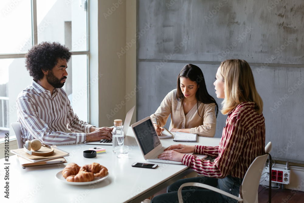 Multiracial colleagues working on project together Multiracial colleagues working on project together