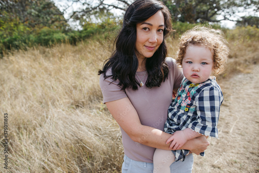 Young mom enjoying quality time with toddler outside. Young mom enjoying quality time with toddler outside.