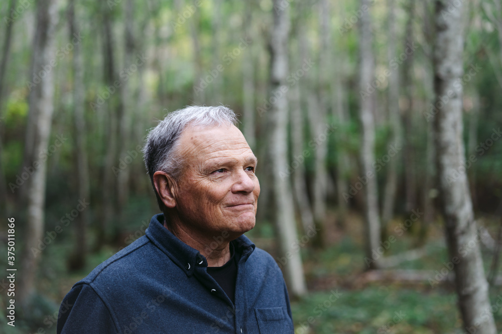 A peacefule, retired age man spending solitude in the forest. A peacefule, retired age man spending solitude in the forest.