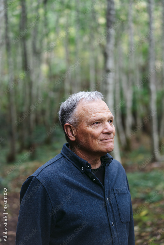 A peacefule, retired age man spending solitude in the forest. A peacefule, retired age man spending solitude in the forest.