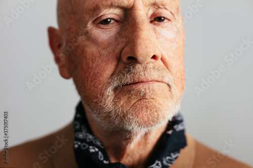 Elderly man looking at camera