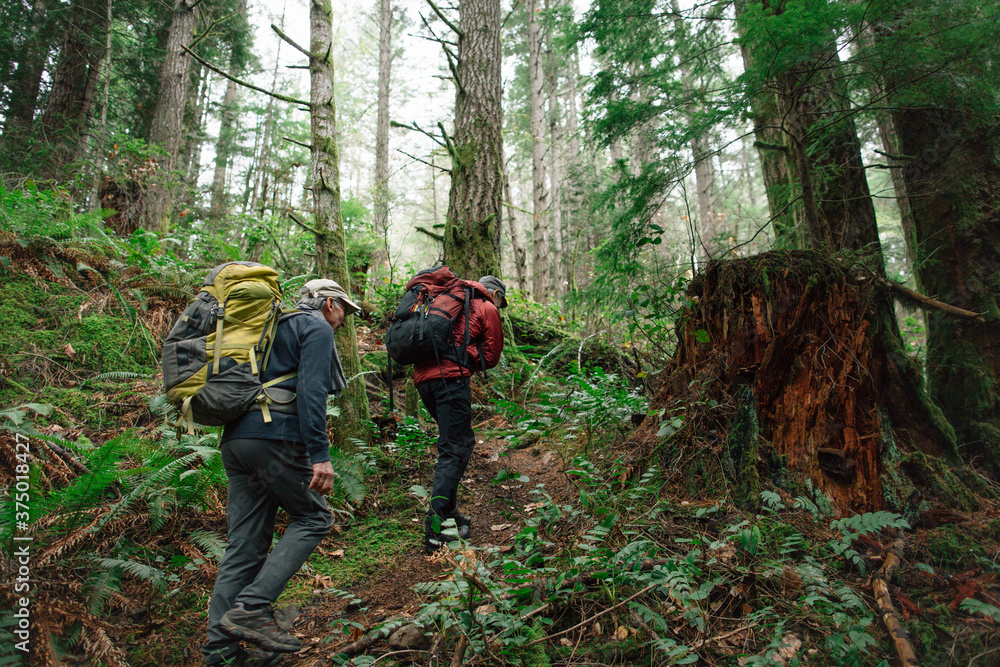 Two mature rock climbing friends hiking to spot together. Two mature rock climbing friends hiking to spot together.