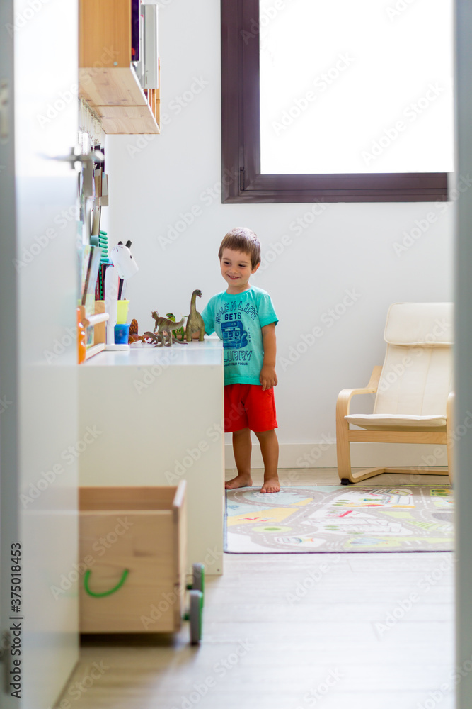 Little Boy Playing With Dinosaurs In Playroom Little Boy Playing With Dinosaurs In Playroom