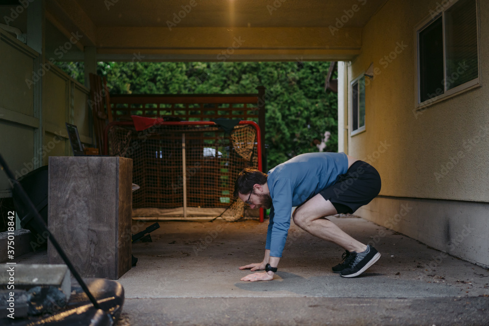 Home workout in the driveway with laptop. Home workout in the driveway with laptop.